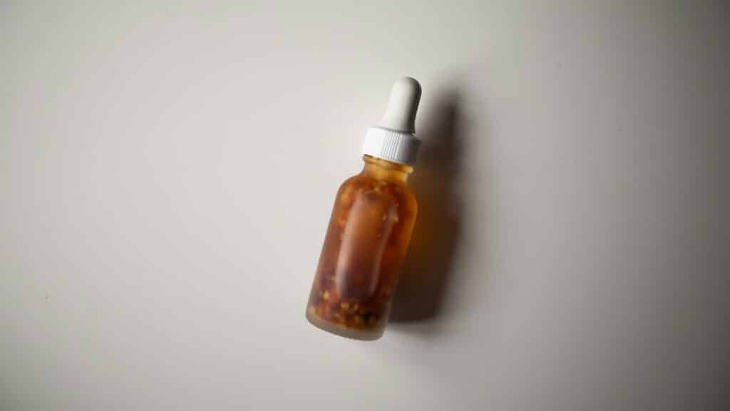Amber dropper bottle on a gray surface