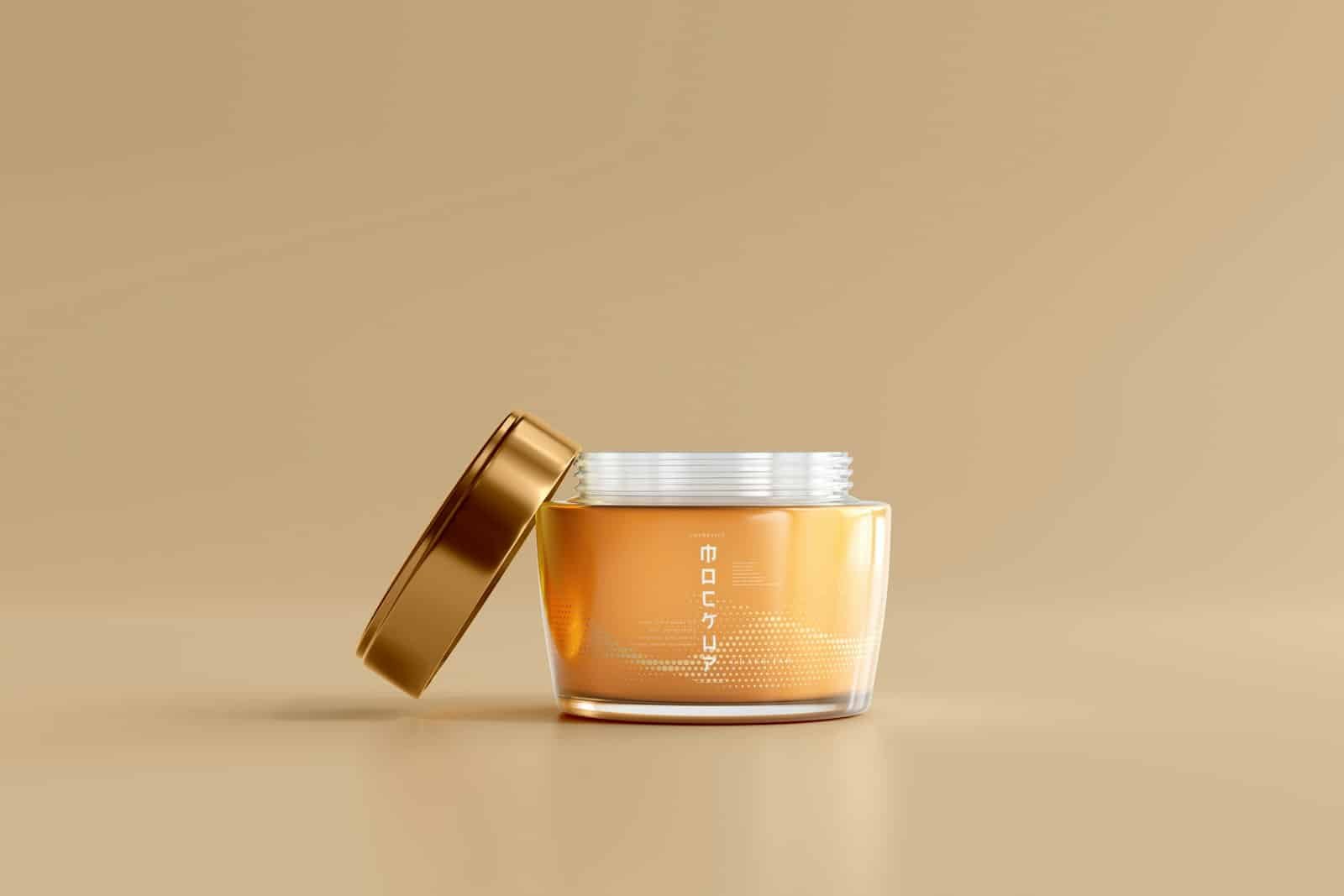 Amber glass jar with a gold lid on a beige background
