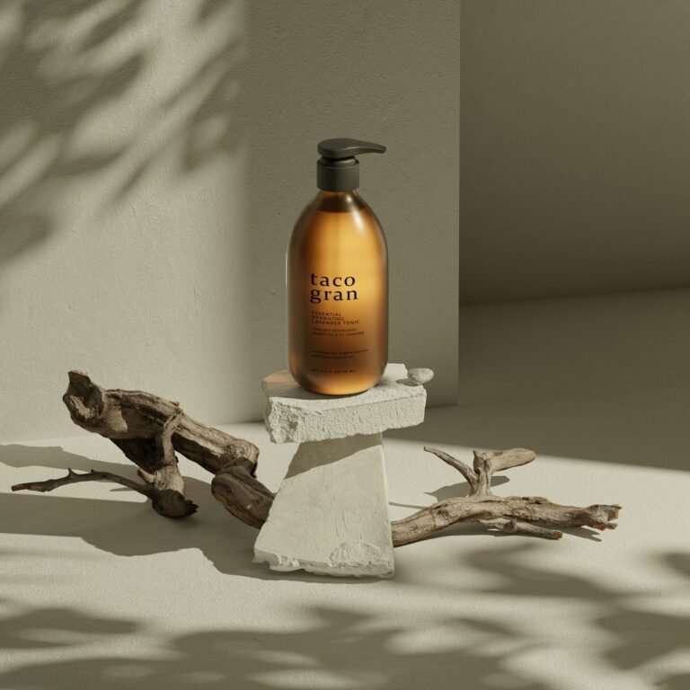 Amber pump bottle on a stone block with driftwood
