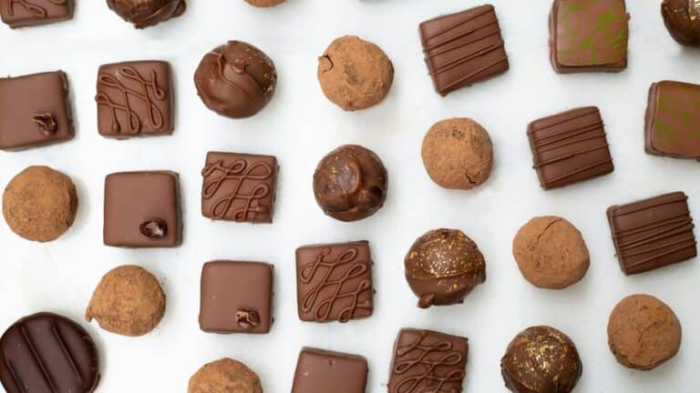Assorted chocolates and truffles on a white surface