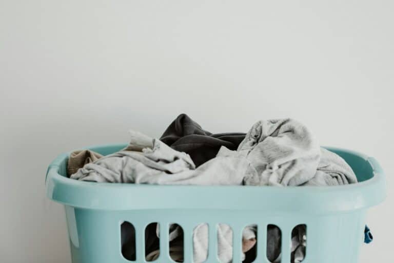 Blue laundry basket full of clothes