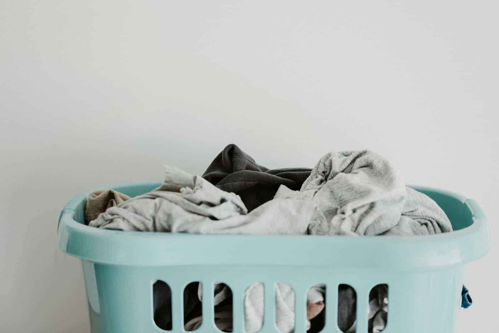Blue laundry basket full of clothes