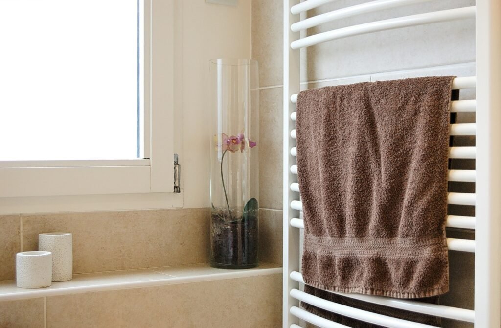 Brown towel hanging on a heated towel rail in a bathroom