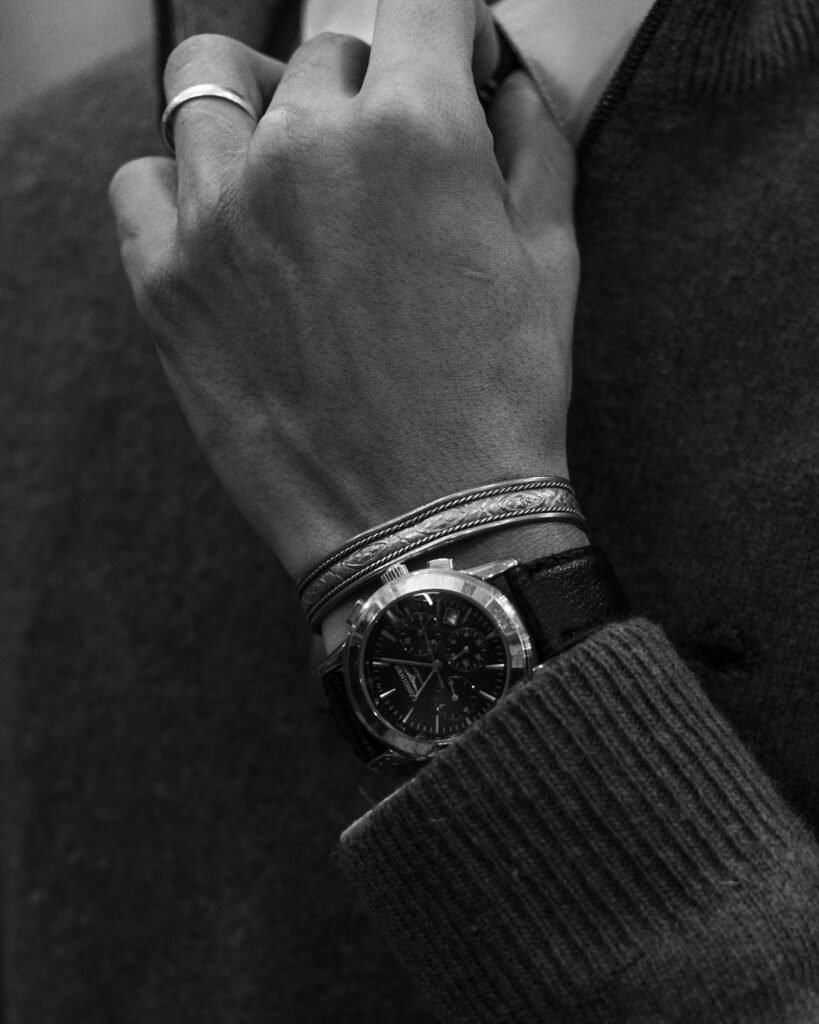 Close-up of a hand with a wristwatch and bracelets
