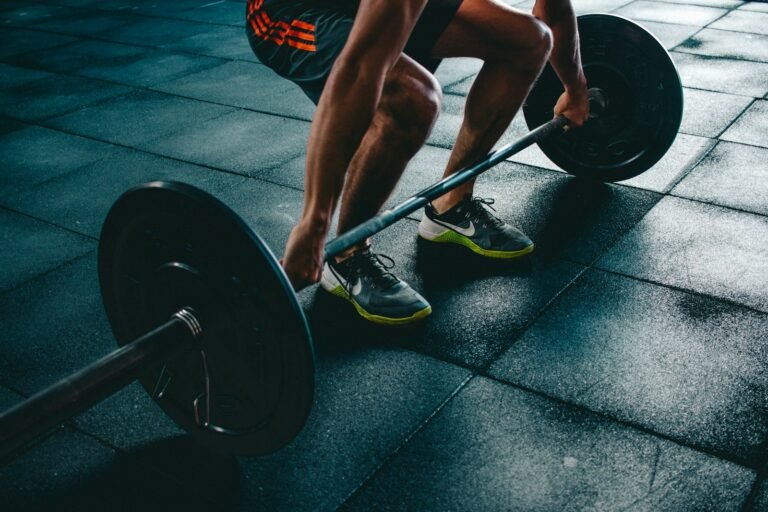 Close-up of a man gripping a barbell before a lift