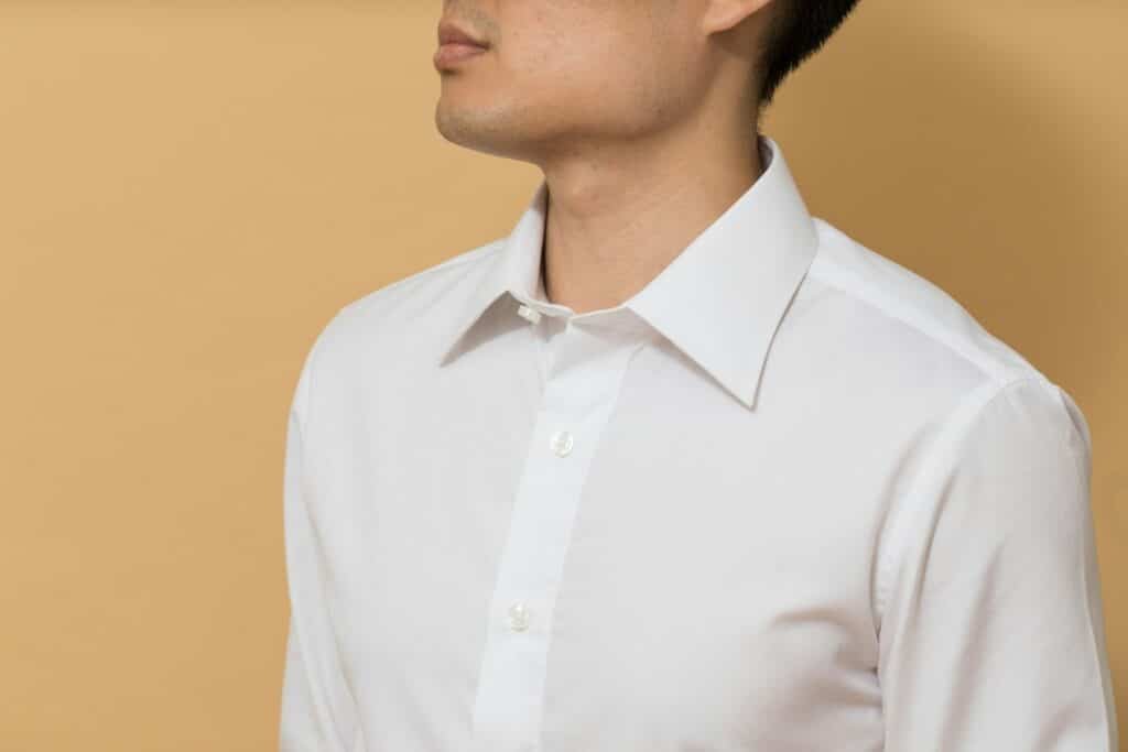 Close-up of a man wearing a crisp white dress shirt