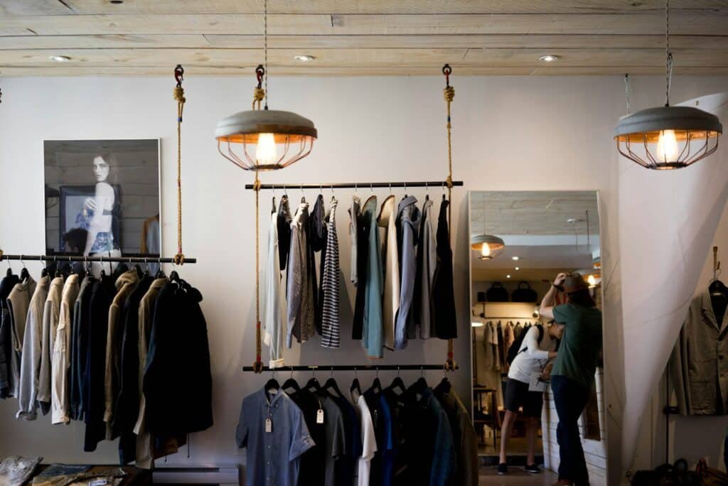 Clothing boutique interior with hanging racks and pendant lights