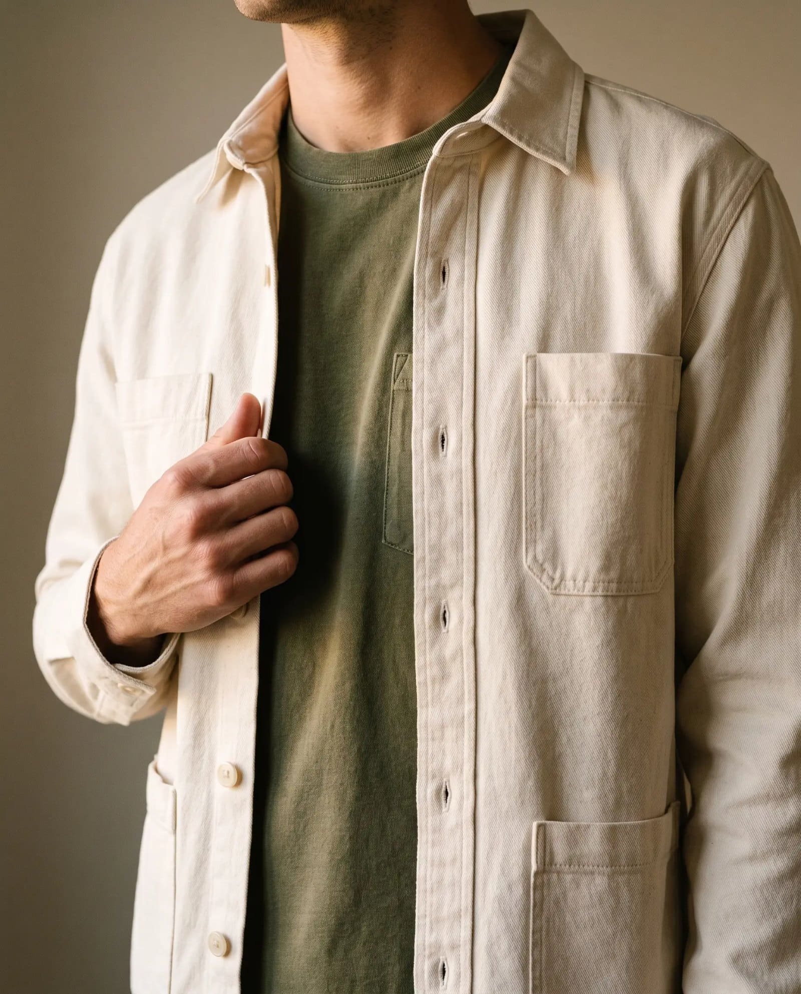 Close-up of the Corridor Misha overshirt in Natural over an olive garment dye tee