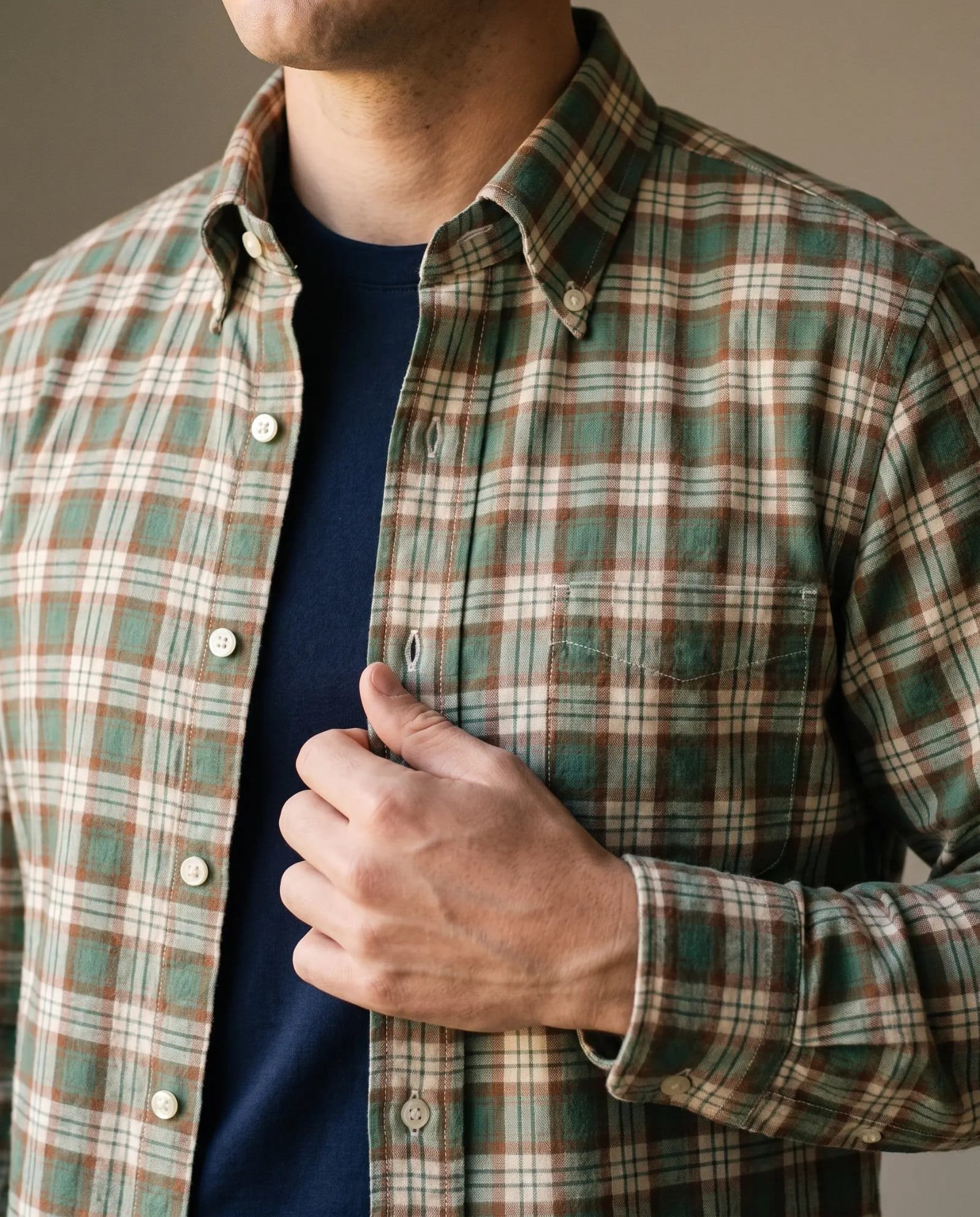Close-up of the Sid Mashburn madras sport shirt collar and buttons over a navy tee