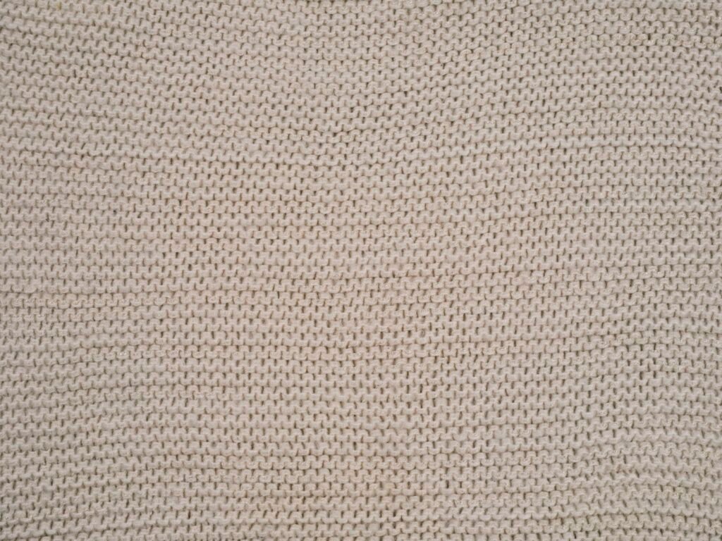 Close-up of a fine knit fabric showing the stitch texture