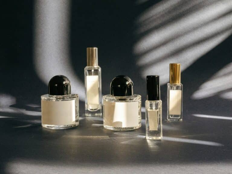 Fragrance bottles on a table in dappled sunlight