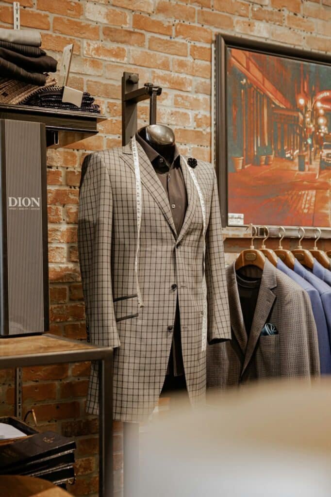 Gray plaid suit jacket on a mannequin in a menswear shop