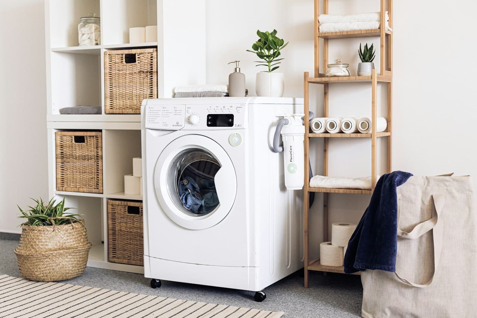 Laundry nook with a front-loading washer and storage shelves
