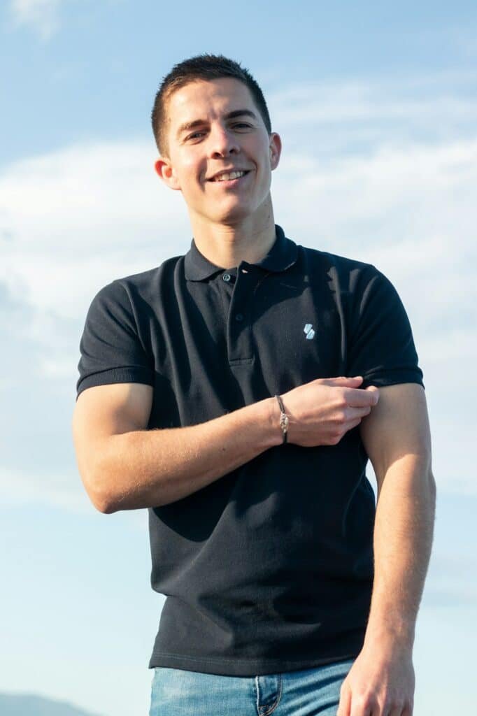 Man in a black polo shirt outdoors