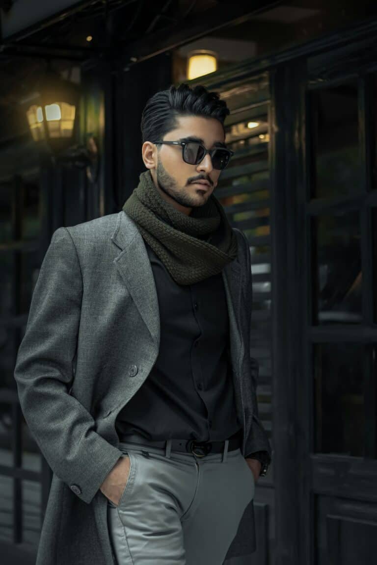 Man in a grey wool coat, black scarf and sunglasses