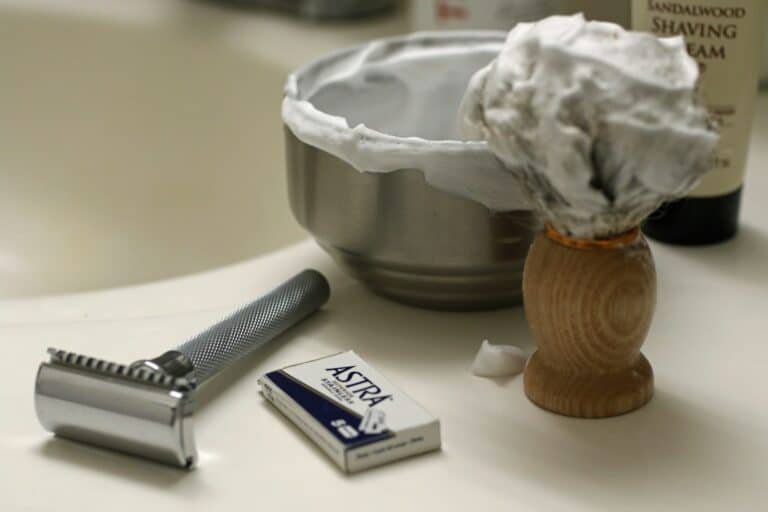Safety razor, blades, shaving bowl with lather and a shaving brush