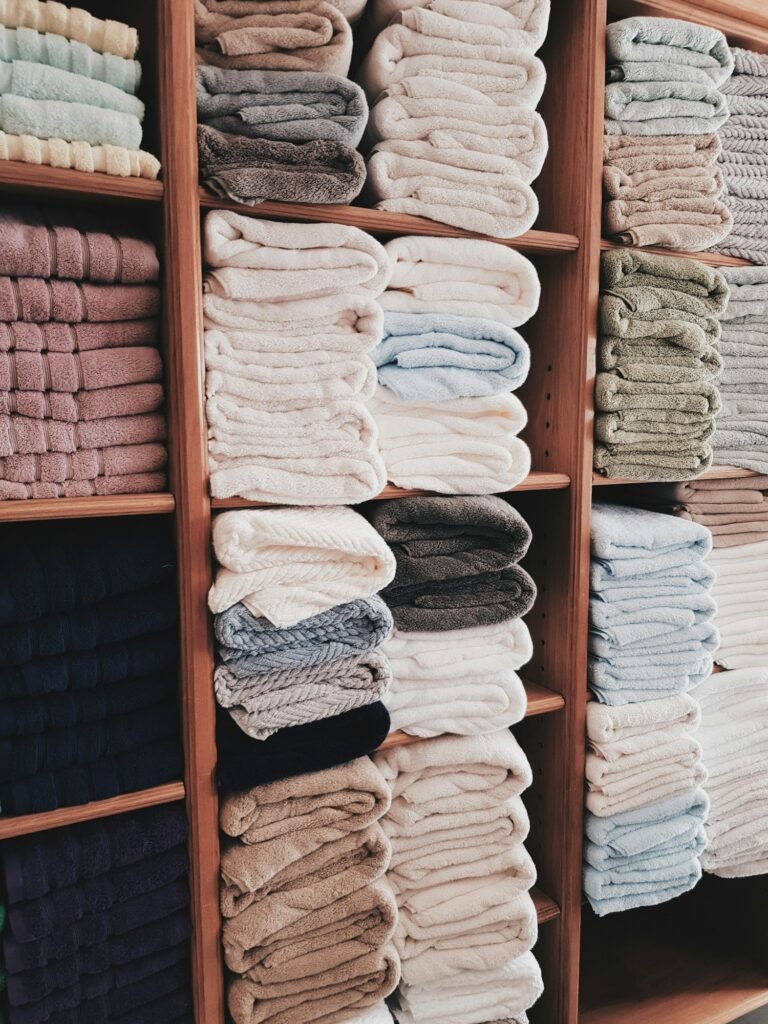 Shelves of neatly folded towels in different colors