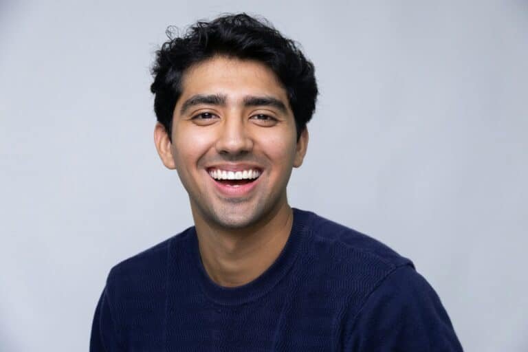Smiling young man in a navy sweater