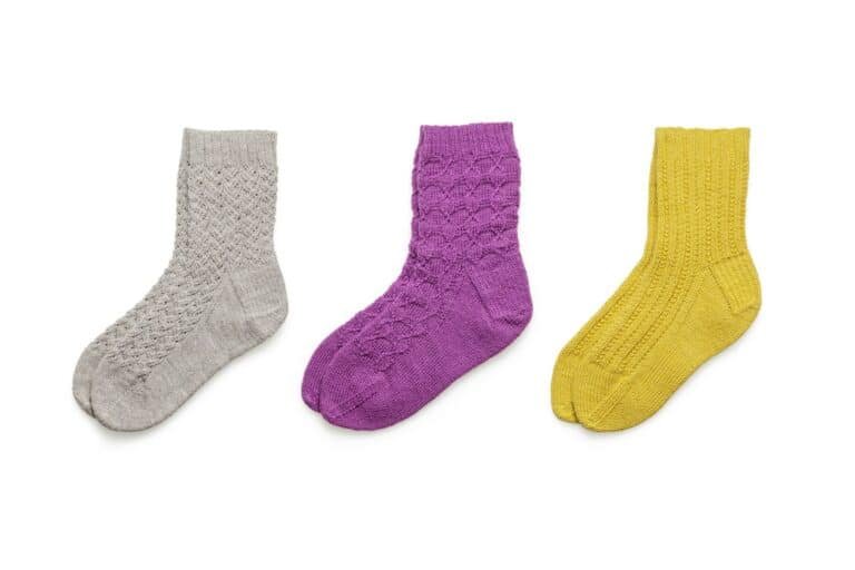 Three textured socks in gray, purple and yellow