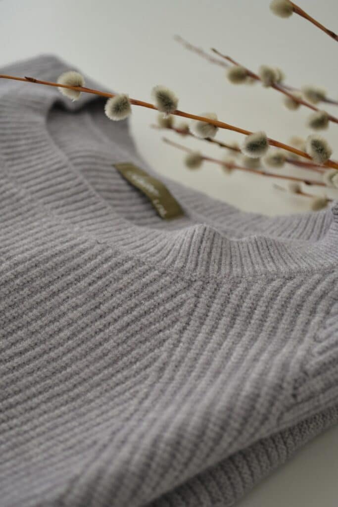 Close-up of a gray ribbed knit sweater collar