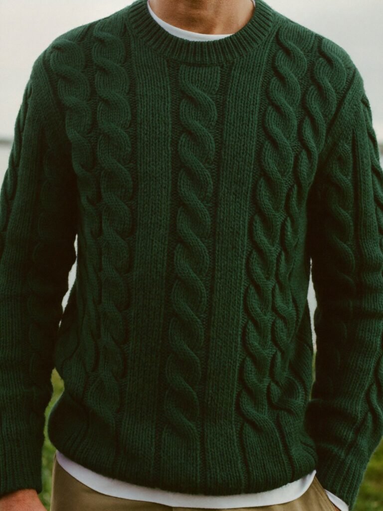 Green cable-knit fisherman sweater over a white tee